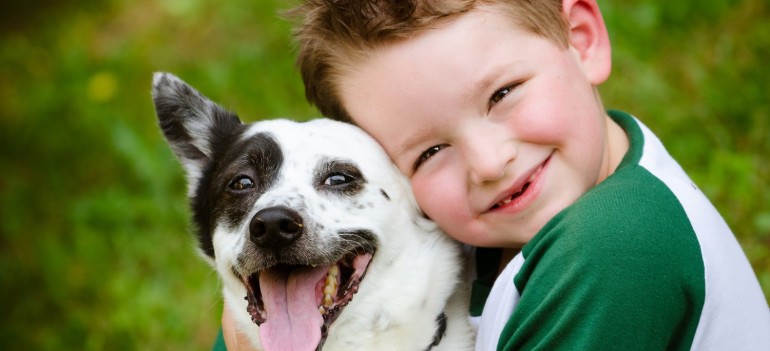 Child-lovingly-embraces-his-pet-dog